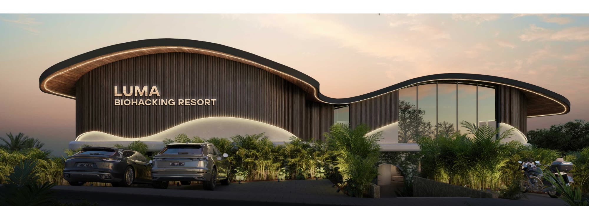 Luma Biohacking Resort's curved timber facade at dusk, Uluwatu cliffside