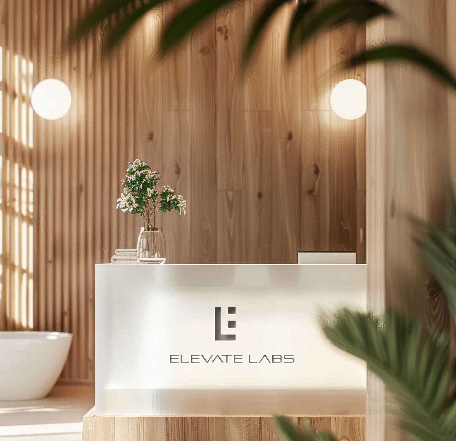 Reception of the biohacking clinic with the Elevate Labs logo, warm wood slats, soft globe lights and plants