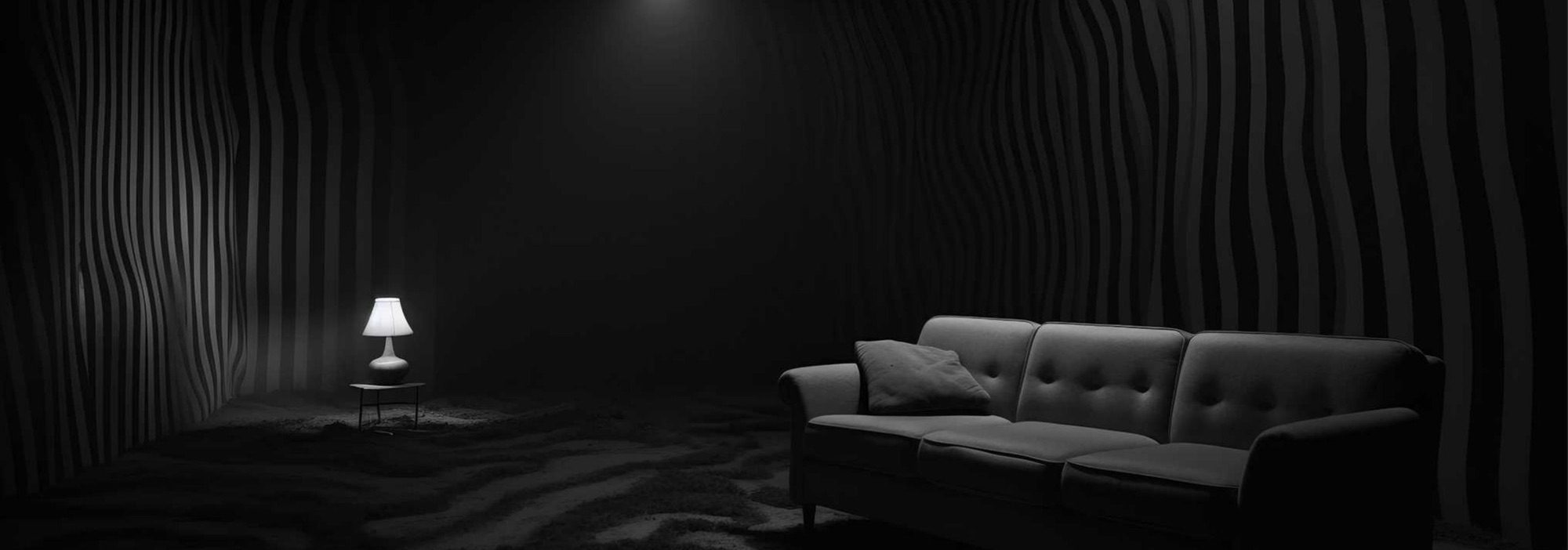 Dark retreat room with wavy sound-absorbing walls lit by a single warm lamp