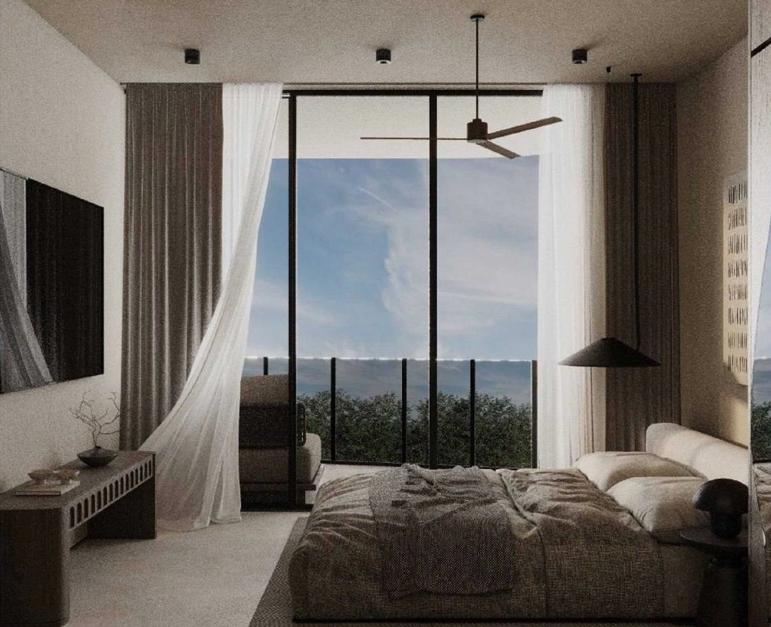 Studio residence with a low bed, ceiling fan and floor-to-ceiling glass onto the ocean horizon
